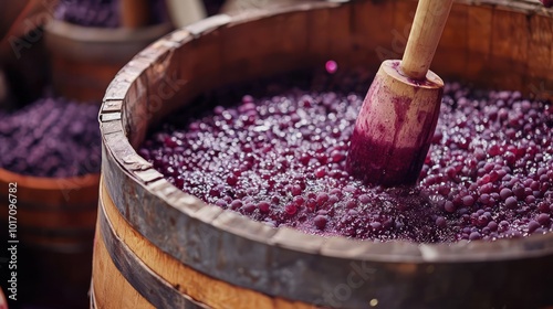 Artisanal wine-making process with grapes being crushed in a wooden vat.