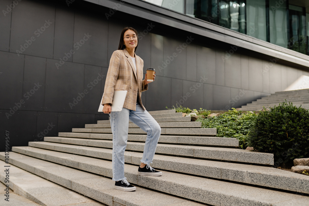 young pretty asian woman walking outside in street doing business young pretty asian woman walking outside in street doing business