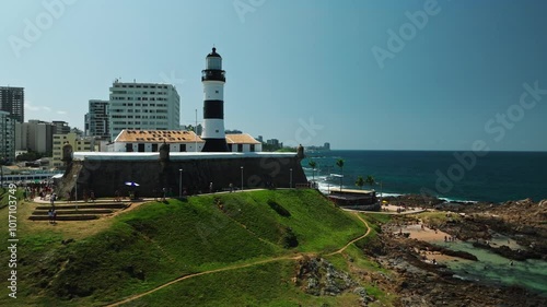 Aerial view of Salvador da Bahia cityscape, Barra Lighthouse, beach and azure sea. Tropical Travel Destination. Aerial landscape of Coastal City. Salvador, Bahia, Brazil.