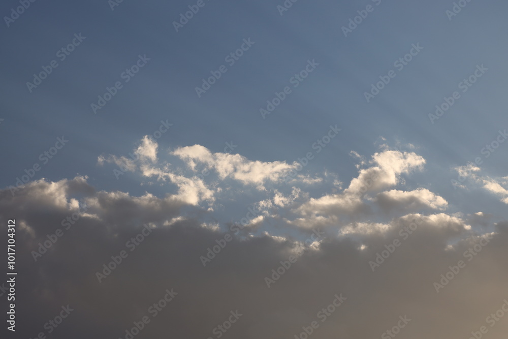 small higher clouds glow brilliant white in sunlight above dark heavy storm clouds small higher clouds glow brilliant white in sunlight above dark heavy storm clouds