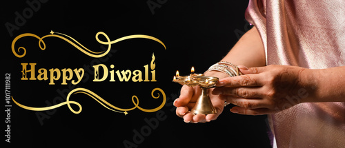 Woman holding diya lamp for...
