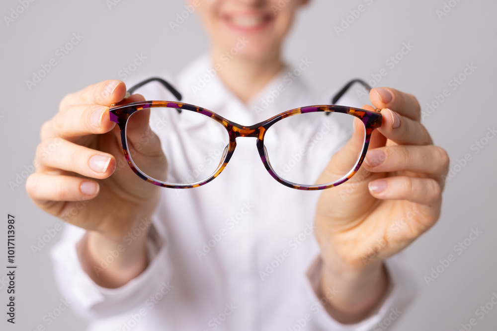 Poor vision concept, woman with poor vision holding glasses in front of her Poor vision concept, woman with poor vision holding glasses in front of her