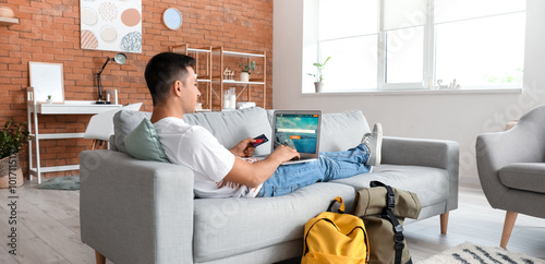 Man with laptop booking tic...