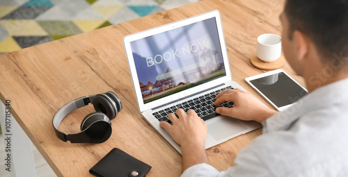 Man with laptop booking roo...