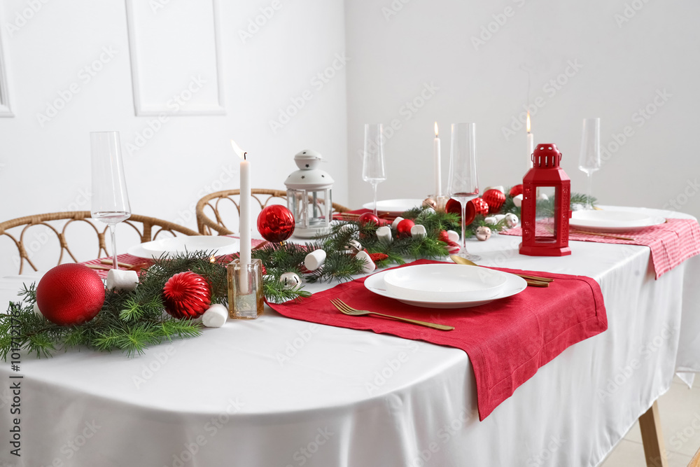 Festive table setting with clean plates, cutlery and Christmas decorations Festive table setting with clean plates, cutlery and Christmas decorations