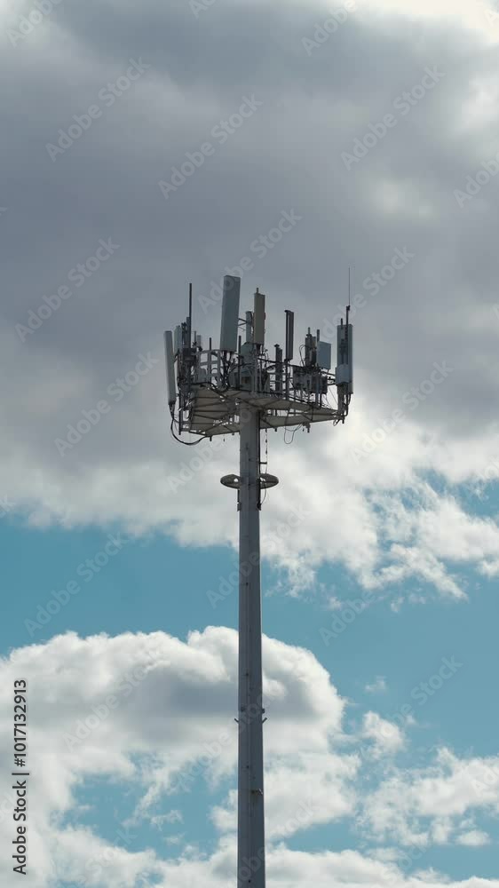 5g mobile network communication tower with cellular antenna transmitter and receiver, broadcasting 4g lte equipment, phone network station on sky with clouds background, vertical video footage 4k 5g mobile network communication tower with cellular antenna transmitter and receiver, broadcasting 4g lte equipment, phone network station on sky with clouds background, vertical video footage 4k