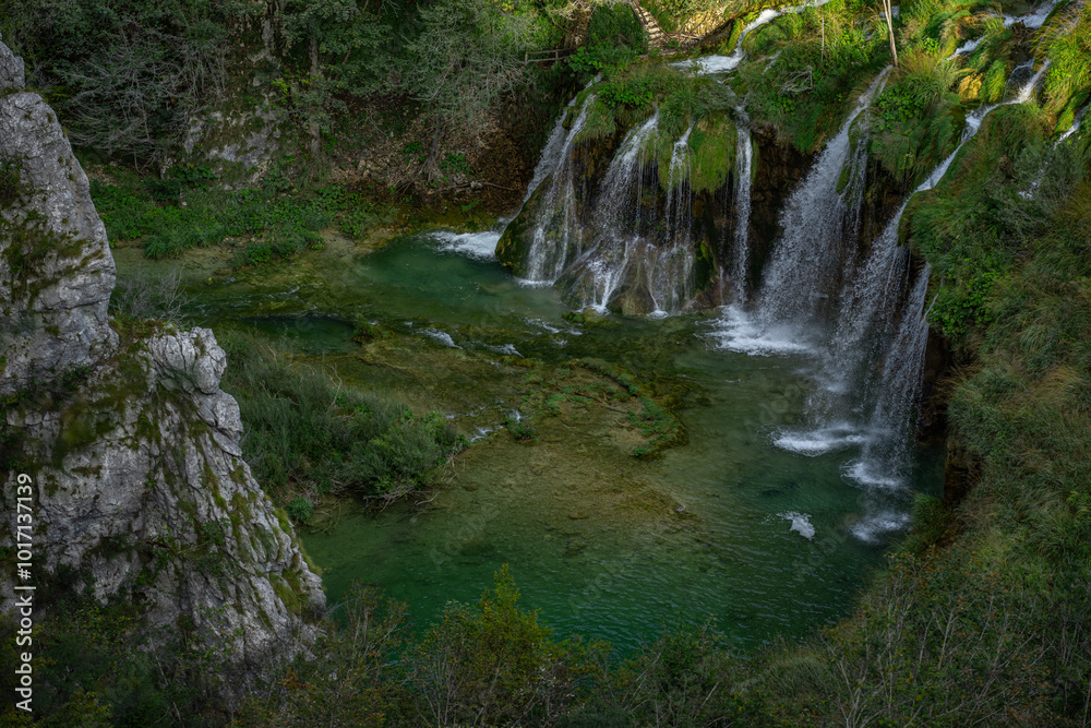 Obraz premium The waterfalls in forest. Summer view of beautiful waterfalls and clear lake. Plitvice Lakes National Park, Croatia. Summer nature landscape.
