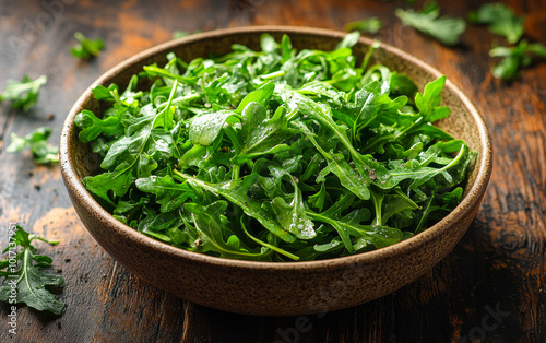 A rustic bowl filled with freshly washed arugula leaves resting on a wooden surface, ideal for healthy salads and dishes.