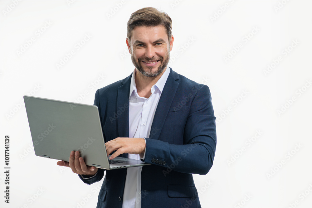 Business man in suit working on laptop in studio. Man checking email on laptop, writing message in social network, using internet, searching information on laptops. Man using laptop computer. Business man in suit working on laptop in studio. Man checking email on laptop, writing message in social network, using internet, searching information on laptops. Man using laptop computer.