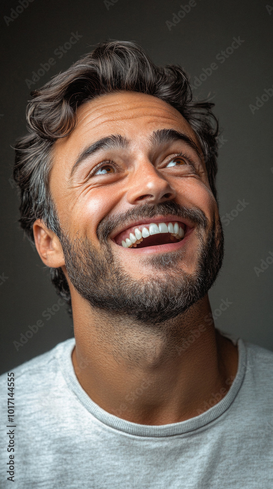 A man with a beard and a smile on his face. He is looking up at something. Concept of happiness and contentment A man with a beard and a smile on his face. He is looking up at something. Concept of happiness and contentment