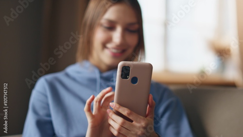 Overjoyed woman looking smartphone surprised by great news in apartment closeup