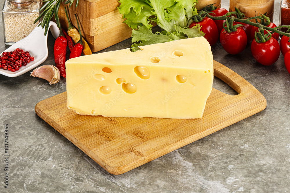 Swiss Maasdam cheese triangle over board Swiss Maasdam cheese triangle over board