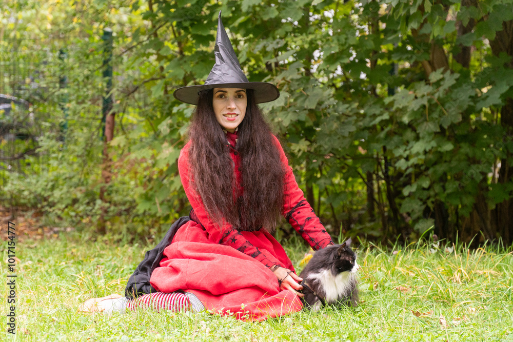 halloween, day of the dead holiday, dressed up witch with cat, black and white cat, pet in nature, cat on a leash, funny witch, fooling around at a party, black cap, red dress halloween, day of the dead holiday, dressed up witch with cat, black and white cat, pet in nature, cat on a leash, funny witch, fooling around at a party, black cap, red dress