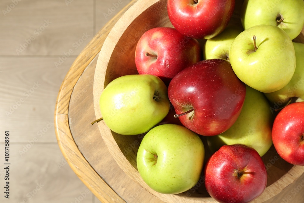 Ripe red and green apples in bowl on wooden chair, top view Ripe red and green apples in bowl on wooden chair, top view