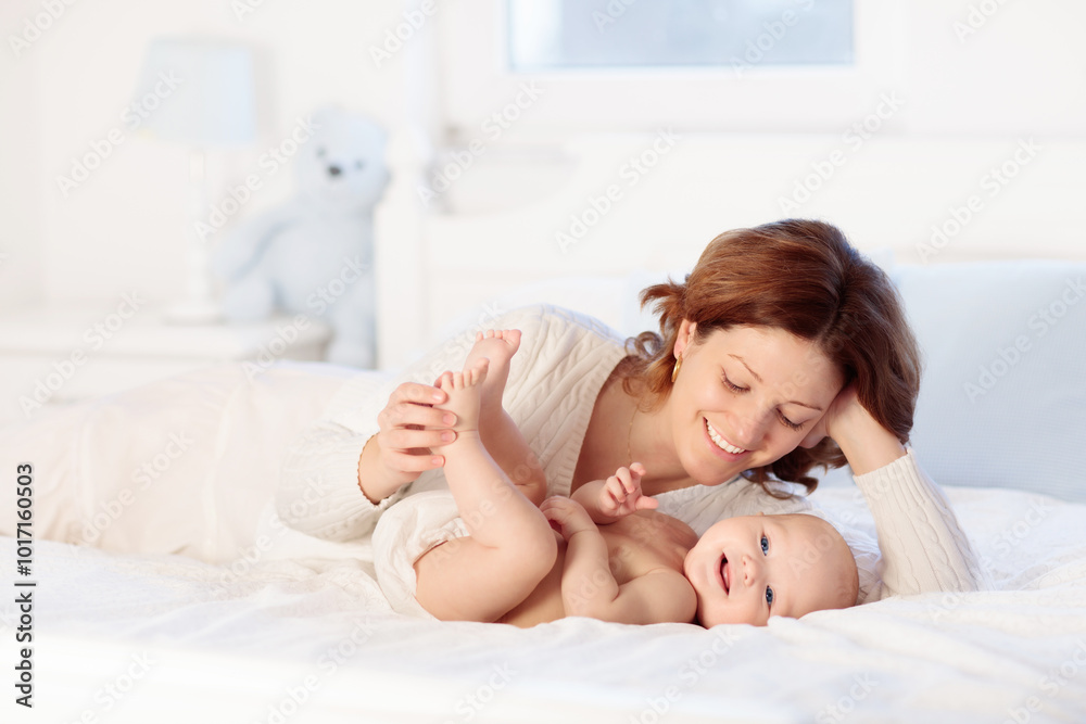 Mother and baby on a white bed Mother and baby on a white bed