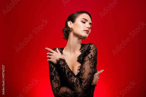 Photo of stunning tender lovely lady in black dress hug heself isolated on red color background