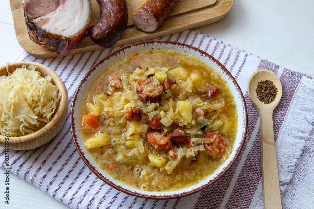 Kapuśniak - homemade, traditional Polish soup made of sauerkraut with potatoes, bacon and sausage Kapuśniak - homemade, traditional Polish soup made of sauerkraut with potatoes, bacon and sausage