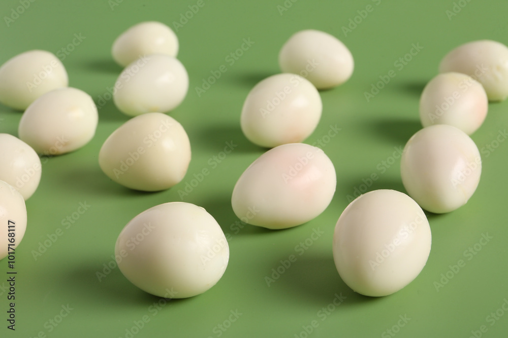 Fresh boiled quail eggs on green background Fresh boiled quail eggs on green background