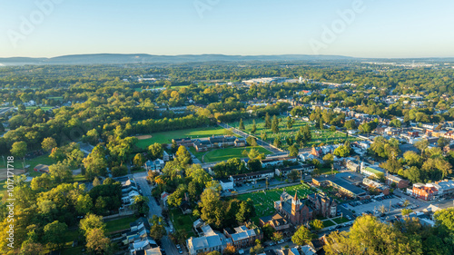 Aerial view of Carlisle, PA, showcasing a mix of residential, commercial buildings, and tree-lined streets under a clear morning sky.