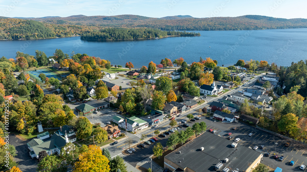 Αυτοκόλλητο Aerial view of Schroon Lake, New York, showcasing the calm lake, fall foliage, and small town structures nestled along the shoreline under a clear sky