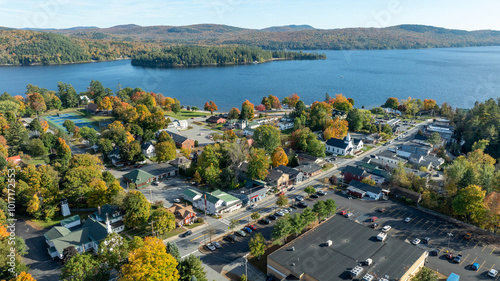 Konstfotografi Aerial view of Schroon Lake, New York, showcasing the calm lake, fall foliage, and small town structures nestled along the shoreline under a clear sky