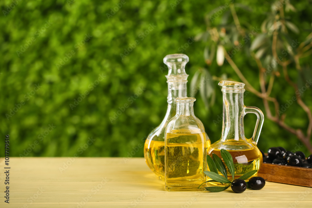 Decanters and bottle of fresh olive oil on wooden table outdoors Decanters and bottle of fresh olive oil on wooden table outdoors