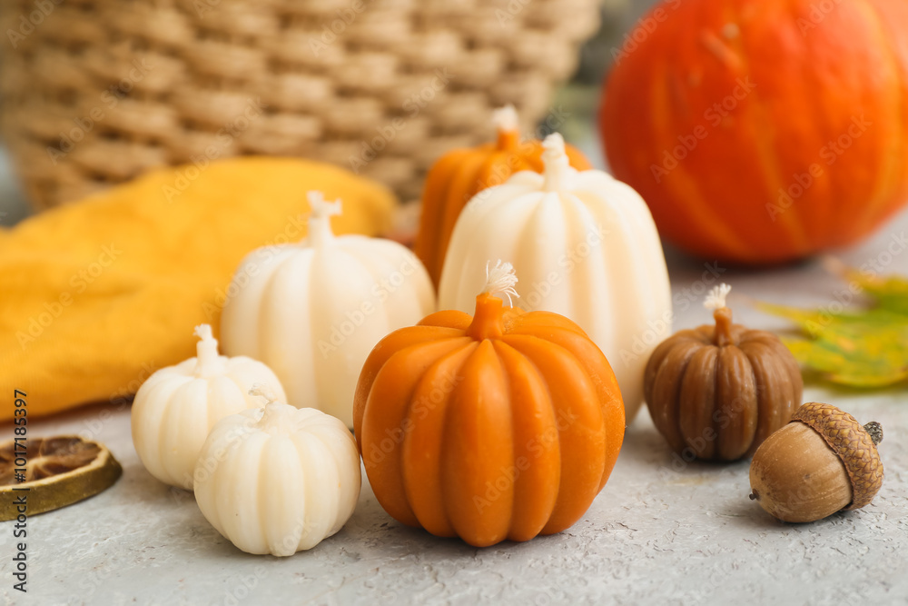 Beautiful autumn candles in shape of pumpkins on light table Beautiful autumn candles in shape of pumpkins on light table