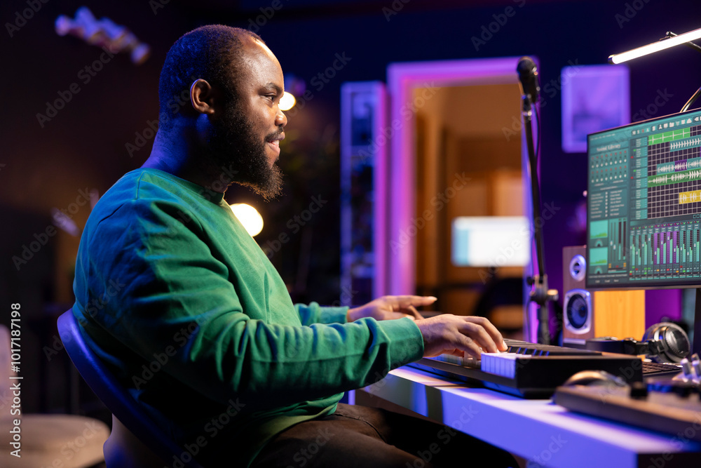 Sound engineer pressing keys of electronic synthesizer and composing new song, adjusting volume levels on pre amp knobs. Composer producing music on piano midi controller, mixing tunes. Sound engineer pressing keys of electronic synthesizer and composing new song, adjusting volume levels on pre amp knobs. Composer producing music on piano midi controller, mixing tunes.