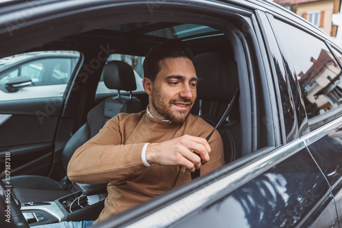 A business man prepares to drive his car around the city