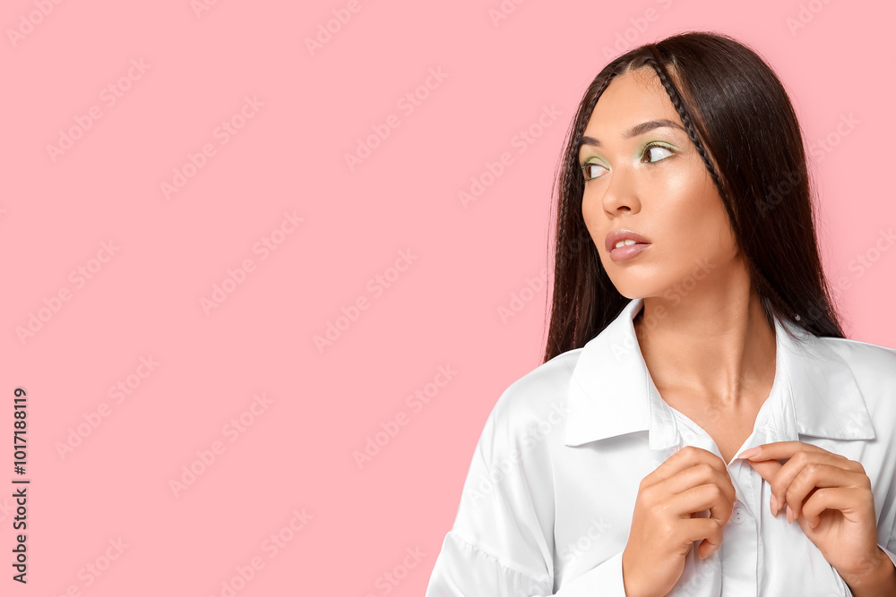 Fashionable young Asian woman with stylish mint makeup on pink background Fashionable young Asian woman with stylish mint makeup on pink background