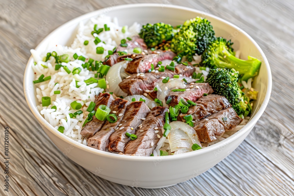 Delicious beef and broccoli florets stir fry served in a white bowl with savory soy sauce and rice Delicious beef and broccoli florets stir fry served in a white bowl with savory soy sauce and rice