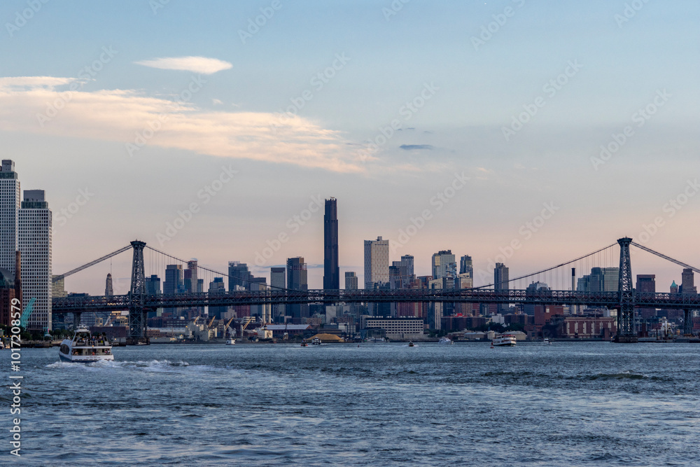 Golden hour illuminates the New York City skyline with silhouettes of Manhattan skyscrapers Golden hour illuminates the New York City skyline with silhouettes of Manhattan skyscrapers