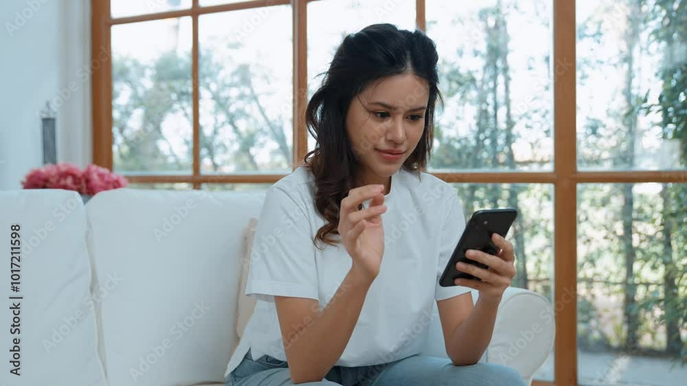 Young woman using smartphone browsing for online shopping E commerce by online payment gateway at vivancy home. Modern and convenience online purchasing make secure and convenient purchases. Young woman using smartphone browsing for online shopping E commerce by online payment gateway at vivancy home. Modern and convenience online purchasing make secure and convenient purchases.