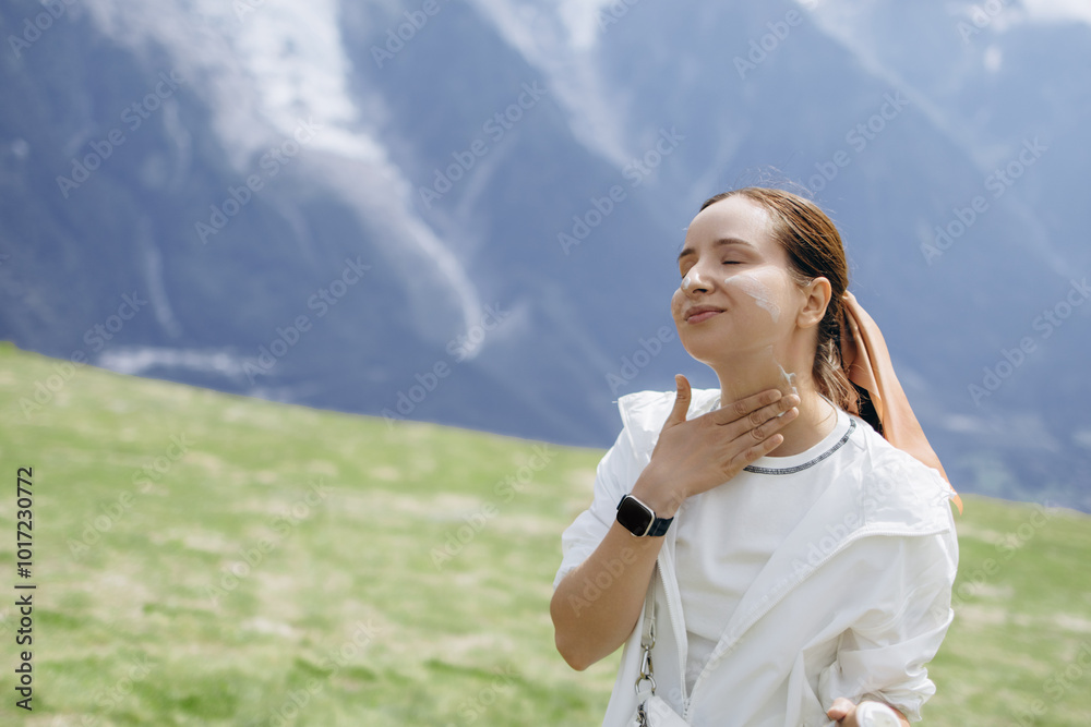 Female Hiker Is Applying Spf Sunscreen To Her Face, Protecting Her Skin From The Sun. Cancer Prevention Concept Female Hiker Is Applying Spf Sunscreen To Her Face, Protecting Her Skin From The Sun. Cancer Prevention Concept