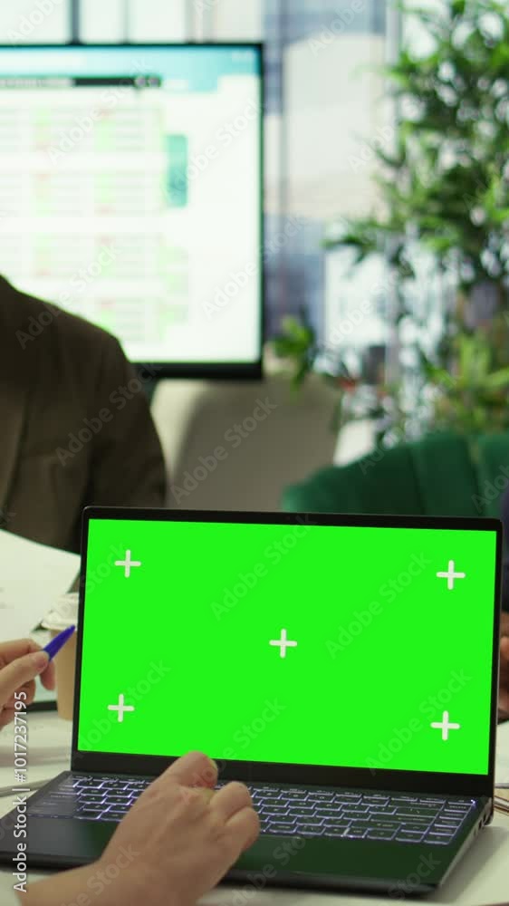 Vertical Video Diverse team of business associates looking at mockup chroma key screen during executive board meeting, utilizing smart technology. Enterprise staff develop effective business Vertical Video Diverse team of business associates looking at mockup chroma key screen during executive board meeting, utilizing smart technology. Enterprise staff develop effective business