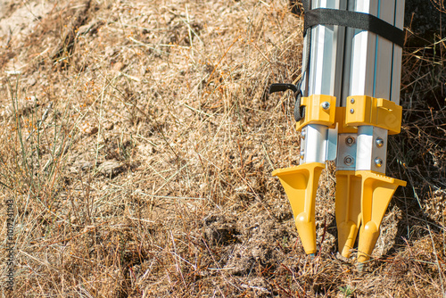 view of the legs of a tripod for surveying devices, copy space and survey concept photo