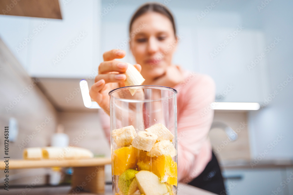 Healthy eating lifestyle concept photo of young woman preparing drink with fruit and vegetables at home in kitchen. Healthy eating lifestyle concept photo of young woman preparing drink with fruit and vegetables at home in kitchen.