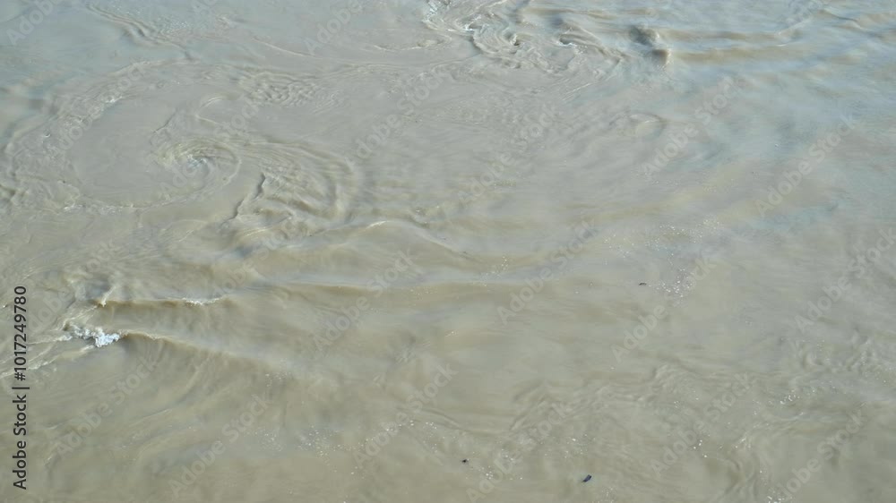 Shallow water current creating sand patterns. Shallow water currents create intricate sand patterns on the riverbed, showcasing the beauty of nature's flow. Shallow water current creating sand patterns. Shallow water currents create intricate sand patterns on the riverbed, showcasing the beauty of nature's flow.