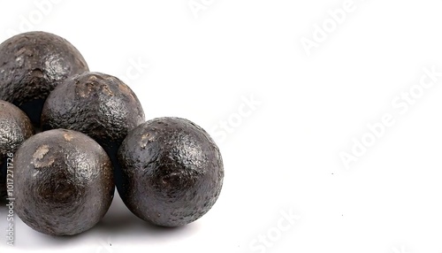 cast iron cannonball is a solid round shot or ball spherical projectile without explosive charge, launched from a cannon gun barrel. Isolated on white background with copy space