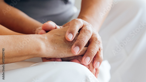 Close up view of caring elderly grandma wife holding hand supporting senior grandpa husband give empathy care love, old married grandparents couple together