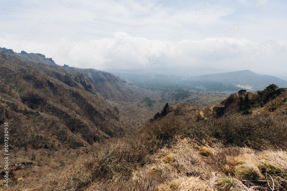 Naklejka premium Hallasan National Park, Jeju island, South Korea, spring landscape view of Yeongsil trail, Halla volcano peak, trekking and climbing to Halla mountain, travel and hiking in Korea, Jeju-do, sunny day
