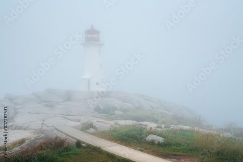 Peggy's Cove lighthouse sits solemnly in an Atlantic fog photo