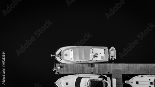 Black and white drone overhead view of a docked boat  photo