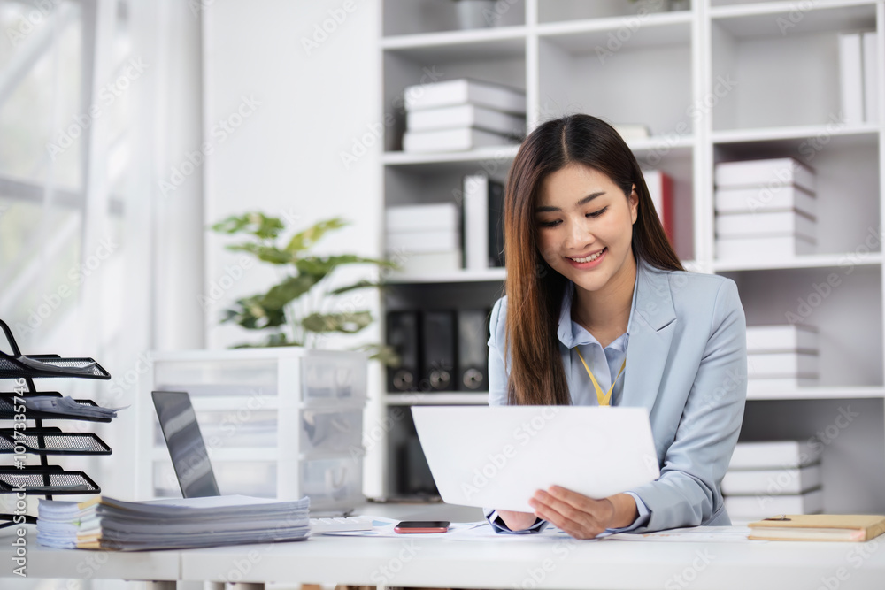 Professional Female Accountant Analyzing Financial Management Documents in a Modern Office Setting Professional Female Accountant Analyzing Financial Management Documents in a Modern Office Setting