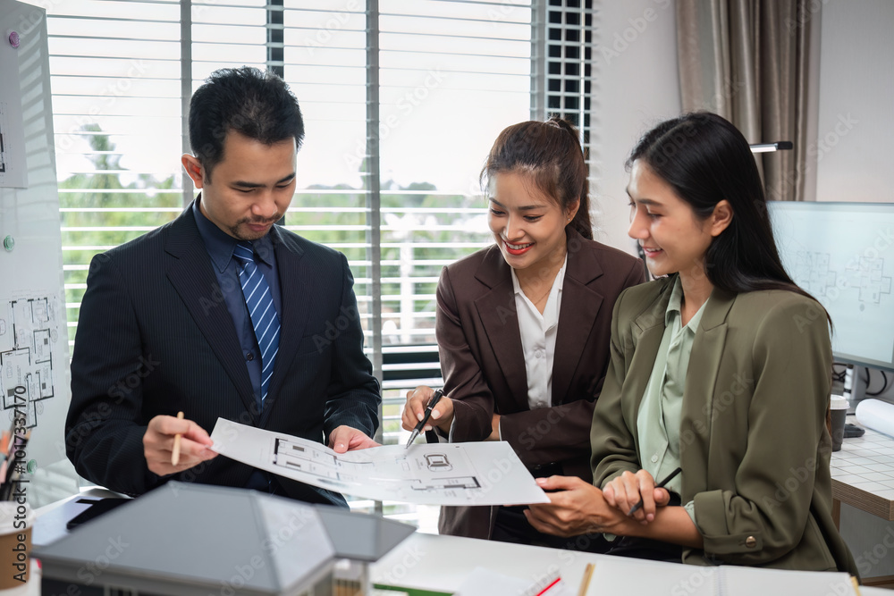 Real Estate Agents Collaborating on Marketing Plans in Modern Office Setting Real Estate Agents Collaborating on Marketing Plans in Modern Office Setting