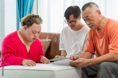 Senior man and grandchild practice math skill, interactive math game, Grandfather supervising grandchild sitting at sofa doing homework