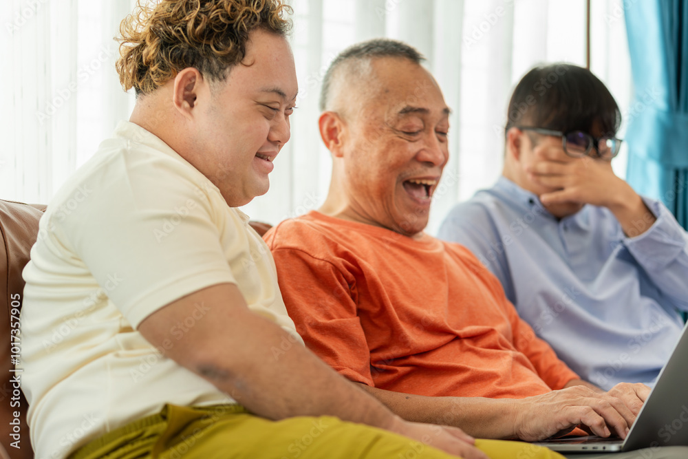 Senior asian man having a good time sitting on couch at home with adult son, Cheerful grandfather and grandson using laptop doing a video call in living room Senior asian man having a good time sitting on couch at home with adult son, Cheerful grandfather and grandson using laptop doing a video call in living room