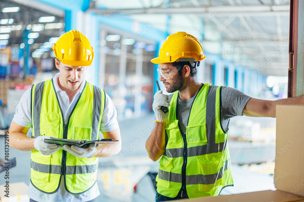 Three warehouse workers using a digital tablet while recording inventory. Logistics employees working with warehouse management software in a large distribution centre. Three warehouse workers using a digital tablet while recording inventory. Logistics employees working with warehouse management software in a large distribution centre.