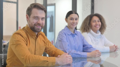 Mixed Race People Smiling at Camera in Office