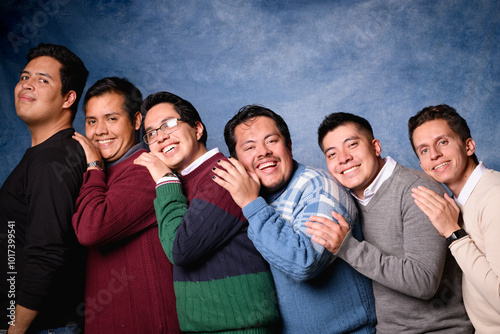 Group of 6 men in sweater on blue background in 90's yearbook style. Posing in a romantic way